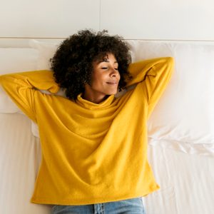 woman laying in bed relaxing