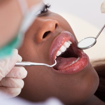 High angle view of female patient being examined by dentist in clinic