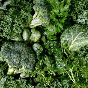 Green vegetables and dark leafy food background as a healthy eating concept of fresh garden produce organically grown as a symbol of health as kale swiss chard spinach collards broccoli and cabbage.