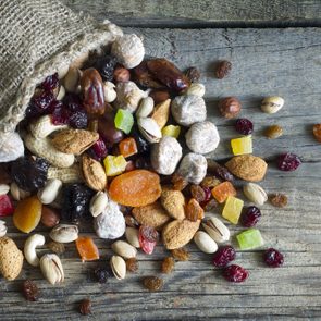 Nuts and dried fruits on vintage wooden boards still life