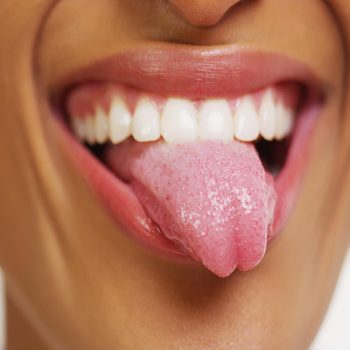 Close up of African woman with white teeth smiling and sticking