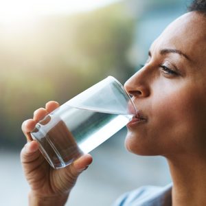 woman drinking a glass of water