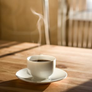 hot coffee in mug on kitchen table