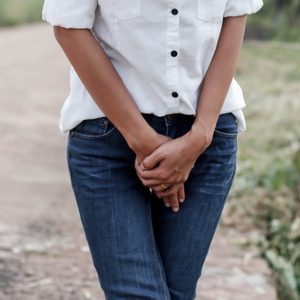 woman with hands holding her crotch