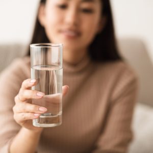 Girl Holding Mineral Water In Glass