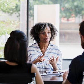 Serious female mental health professional talks with couple