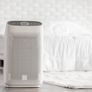 Air purifier in cozy white bed room for filter and cleaning removing dust PM2.5 HEPA in home,for fresh air and healthy life,Air Pollution Concept