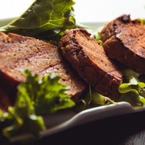 cooked seitan on bed of lettuce