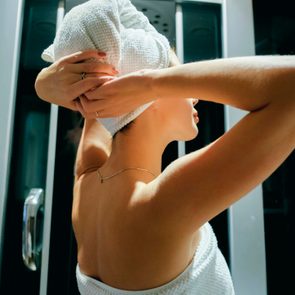 Caucasian woman drying hair with towel