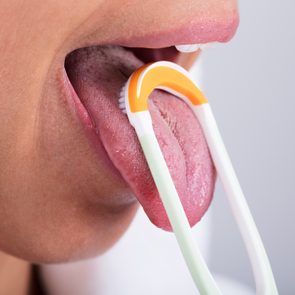 Woman Cleaning Tongue