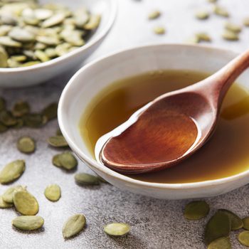 Bowl of pumpkin seed oil and pumpkin seeds