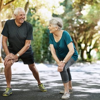 Shot of a senior couple warming up before a run outside