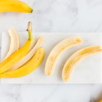 Banana Peel And Bananas On White Marble Board