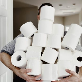 Man Carries Heap of Toilet Paper