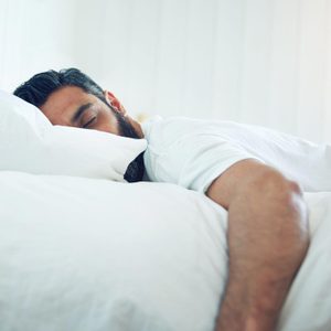 mature man lying on his bed and sleeping