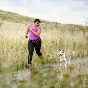 woman running with her dog outside