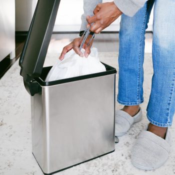 Woman Removes Trash Bag From Can 3